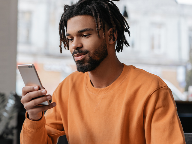 young man holding phone